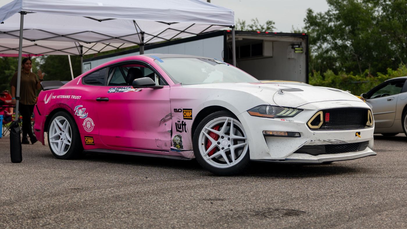 Zach's pink and white 2018 Mustang GT drift car in the paddock
